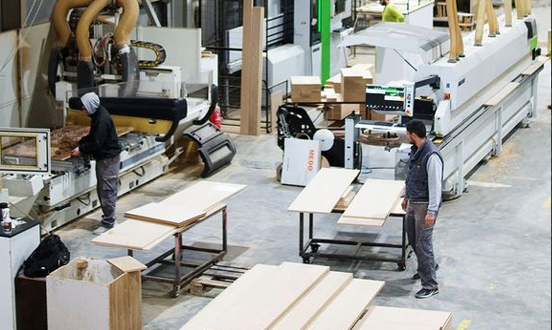 Operators working on a woodworking production floor